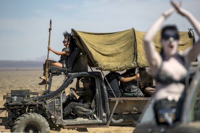 People ride a customized vehicle during Wasteland Weekend event in California City, California September 26, 2015. (Photo by Mario Anzuoni/Reuters)
