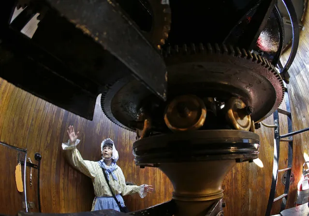 In this August 17, 2016 photo, Sally Snowman, the keeper of Boston Light, gives a tour of the gear room inside the lighthouse on Little Brewster Island in Boston Harbor. The U.S. Coast Guard's last manned station will celebrate the 300th anniversary of its first lighting on September 14th. (Photo by Elise Amendola/AP Photo)