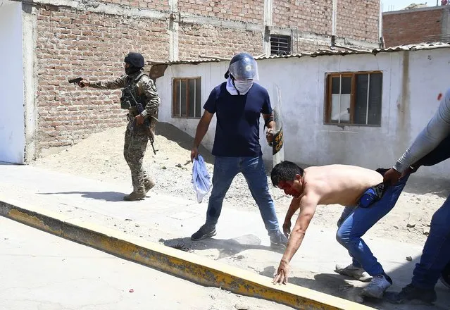 Security forces detain a supporter of ousted Peruvian President Pedro Castillo, on the Pan-American North Highway in Chao, Peru, Thursday, December 15, 2022. (Photo by Hugo Curotto/AP Photo)
