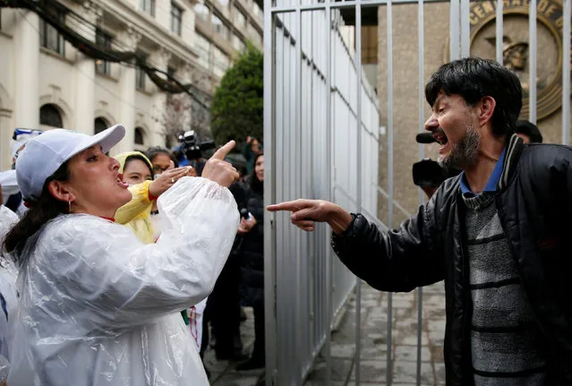 A pedestrian (R) argues with a demonstrator during a rally protest against Bolivia's government new health care policies in La Paz, Bolivia, January 8, 2018. (Photo by David Mercado/Reuters)