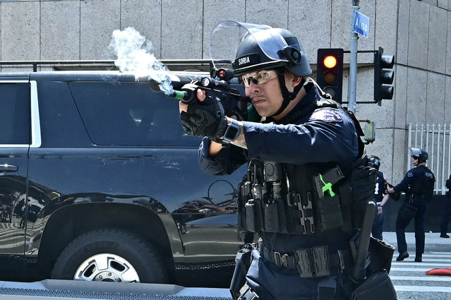 Law enforcement clashes with demonstrators outside the Metropolitan Detention Center, MDC, in downtown Los Angeles, California on June 8, 2025. US President Donald Trump deployed 2,000 troops on June 7 to handle escalating protests against immigration enforcement raids in the Los Angeles area, a move the state's governor termed “purposefully inflammatory”. Federal agents clashed with angry crowds in a Los Angeles suburb as protests stretched into a second night Saturday, shooting flash-bang grenades and shutting part of a freeway amid raids on undocumented migrants, reports said. (Photo by Frederic J. Brown/AFP Photo)