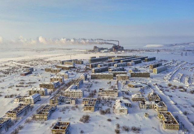 An aerial of abandoned residential area, where harsh arctic climate is gradually destroying buildings, in Zapolyarny village, founded in 1955 during the construction of the Zapolyarnaya coal mine, in Vorkuta, Russia on March 5, 2024. Even though the coal mine is still in operation, the city, hosting almost 400 people nowadays, left its peak years of Soviet era, when population reached almost 10 thousand people, behind. After the collapse of the USSR, most of the population left due to lack of work and abandoned their apartments. (Photo by Alexander Manzyuk/Anadolu via Getty Images)