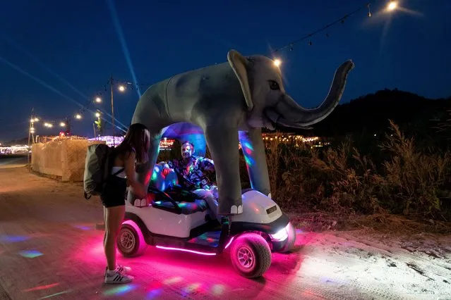 A festival goer catches a ride in an elephant golfcart on the grounds of Wonderfruit Festival on December 16, 2022. Wonderfruit Festival, Day 1 takes place in Chonburi Province on the outskirts of Pattaya, Thailand. (Photo by Matt Hunt/ZUMA Press Wire/Rex Features/Shutterstock)