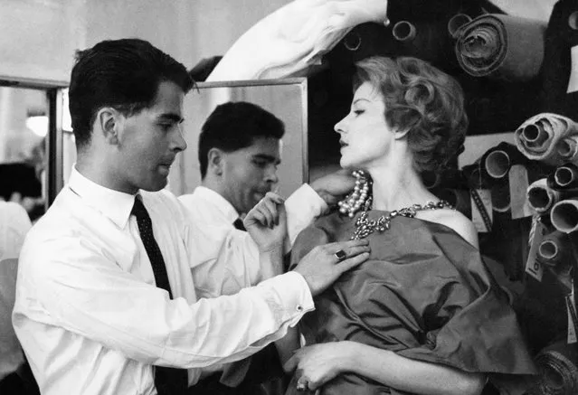 Karl Lagerfeld, fashion designer at Jean Patou, fitting a model in Paris, France, July 21, 1958. (Photo by KEYSTONE-FRANCE/Gamma-Rapho via Getty Images)
