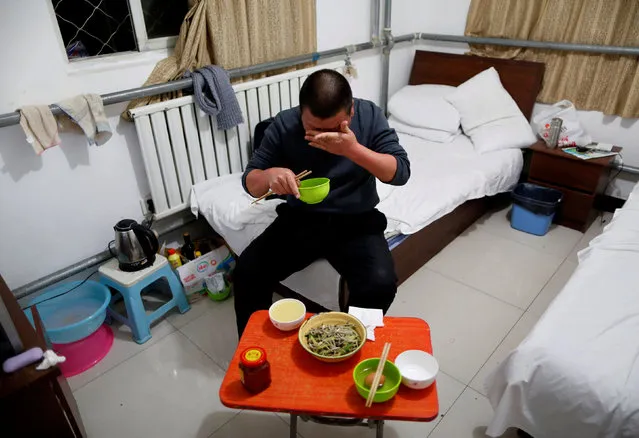 Yuan Yunping wipes sweat from his face as he eats dinner, which his son cooked for him, in his room at the accommodation where some patients and their family members stay while seeking medical treatment in Beijing, China, January 13, 2016. Yuan, who suffers from melanoma, came from Hebei Province to seek specialist treatment in Beijing. (Photo by Kim Kyung-Hoon/Reuters)
