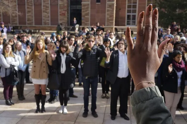 Students at the University of Colorado hold up their hands in support of protesters in Ferguson Missouri, during a demonstration, which was part of a national student walk-out, in Boulder, Colorado December 1, 2014. (Photo by Rick Wilking/Reuters)