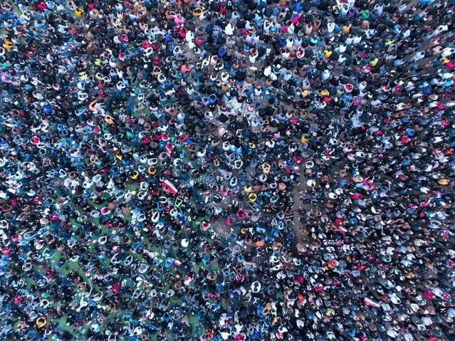 An aerial view shows Iraq supporters gathering in a designated fan zone in Iraq's southern city on January 16, 2023 to watch the Arabian Gulf Cup semi-final football match between Iraq and Qatar. (Photo by Hussein Faleh/AFP Photo)