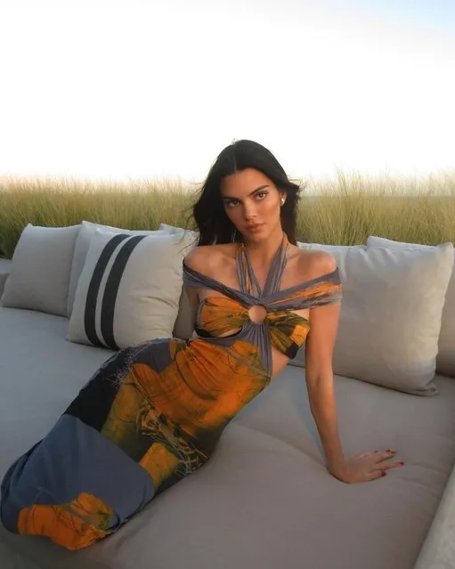 American model, media personality and socialite Kendall Jenner in the second decade of February 2023 lounges in a glamorous dress while outside. (Photo by kendalljenner/Instagram)