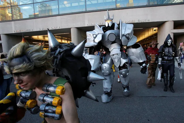 A man in a dressed as Reinhardt from Overwatch walks with other attendees at New York Comic Con in Manhattan, New York, U.S., October 8, 2016. (Photo by Andrew Kelly/Reuters)