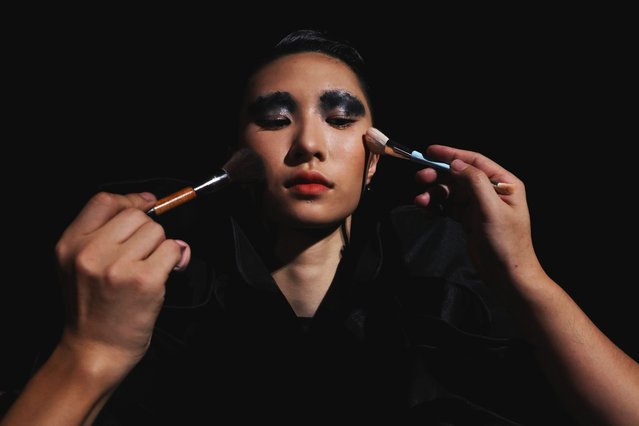 A model has her makeup done backstage, before the 32 Spring/Summer 2026 collection show by Yi Ming, during the China Fashion Week in Beijing, China, on September 12, 2025. (Photo by Tingshu Wang/Reuters)