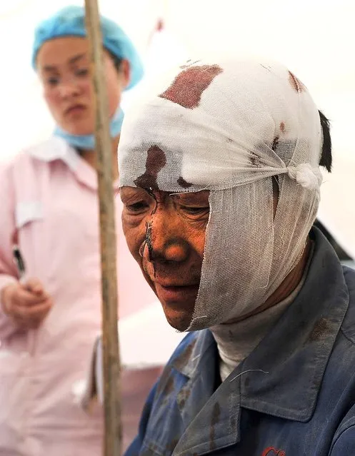 An injured man rests at a temporary treatment station following the earthquake in  southwest China's Sichuan province, on April 20, 2013. (Photo by Associated Press)