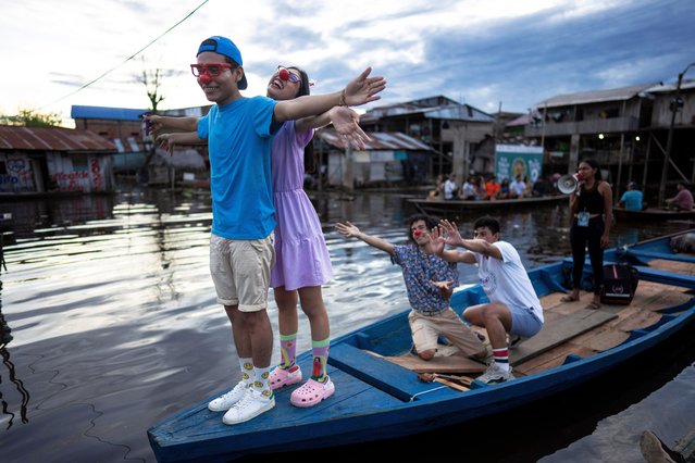 Spectators watch a film from boats during the Muyuna Floating Film Festival, showcasing films from countries with tropical forests, in the Belen neighborhood of Iquitos, Peru, on Sunday, May 26, 2024. (Photo by Rodrigo Abd)/AP Photo