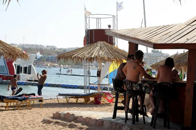 Tourists sit having drinks on the beach in the Red Sea resort of Sharm el-Sheikh, November 7, 2015. (Photo by Asmaa Waguih/Reuters)