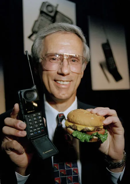 Robert Weisshappel with Motorola Cellular Subscriber Group holds the company's new MicroTac Elite cellular phone and a mock quarter-pound cheeseburger at the Summer Consumer's Electronics Show in Chicago, Il., June 23, 1994. The phone, the lightest most advanced cellular phone currently available in the world, weighs 3.9 ounces, less than the cheeseburger. (Photo by Mark Elias/AP Photo)