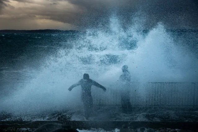 Thrill seekers stand on Charles Richey Sr Viewpoint in West Seattle as the remnants of Typhoon Songda hit western Washington on Saturday, October 15, 2016. (Photo by Grant Hindsley/Seattlepi.com via AP Photo)