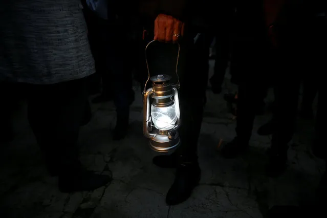 A woman holds a modern version of a kerosene lamp during a rally against energy poverty marking the International Day for the Eradication of Poverty in Madrid, Spain October 17, 2016. (Photo by Susana Vera/Reuters)