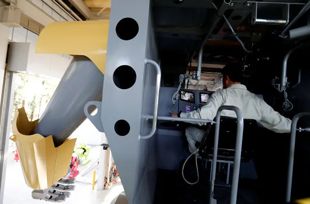 Sakakibara Kikai's engineer Masaaki Nagumo controls the bipedal robot Mononofu from its cockpit during its demonstration at its factory in Shinto Village, Gunma Prefecture, Japan on April 12, 2018. (Photo by Kim Kyung-Hoon/Reuters)