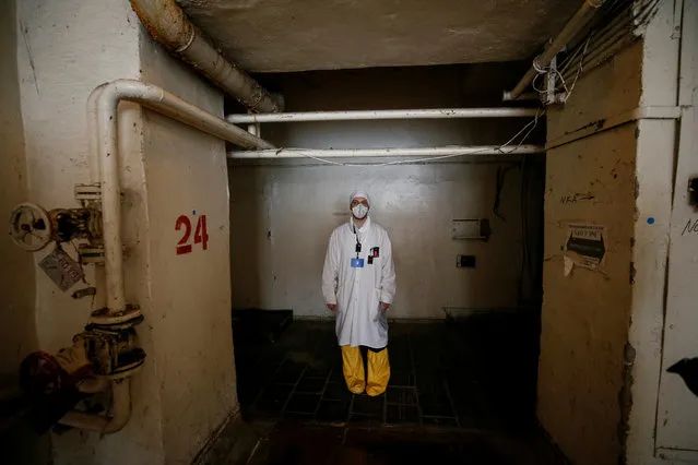 An employee walks through the corridor of the stopped third reactor at the Chernobyl nuclear power plant in Chernobyl, Ukraine April 20, 2018. (Photo by Gleb Garanich/Reuters)