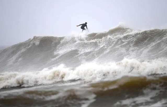 A surfer takes advantage of wild surf conditions at Snapper Rocks on the Gold Coast, Sunday, December 13, 2020. Heavy rainfall, high winds and flooding is forecasted for the region and into northern NSW. (Photo by Dan Peled/AAP Image)