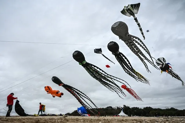 A participant prepares a kite during the 29th edition of the International Kite and Wind Festival as kite flyers from all over France and abroad gather in Chatelaillon-Plage, south-western France, on April 10, 2023. (Photo by Philippe Lopez/AFP Photo)