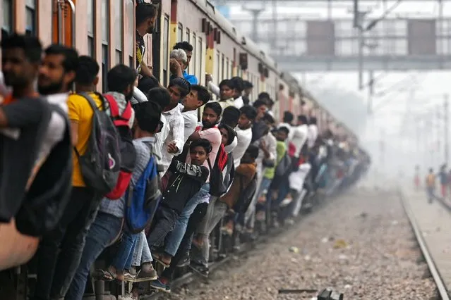 Commuters travel in an overcrowded train near a railway station at Loni town in India's state of Uttar Pradesh on April 24, 2023. India is set to overtake China as the world's most populous country by the end of June, UN estimates showed on April 19, posing huge challenges to a nation with creaking infrastructure and insufficient jobs for millions of young people. (Photo by Arun Sankar/AFP Photo)