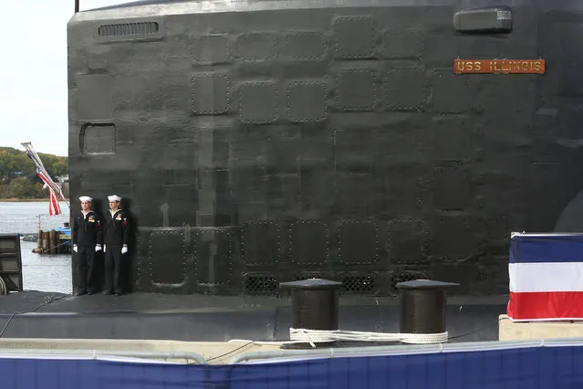 Crew members stand on the topside of the submarine during the commissioning of the USS Illinois, the 13th ship of the Virginia class of submarines, Groton, Connecticut, U.S., October 29, 2016. (Photo by Michelle McLoughlin/Reuters)