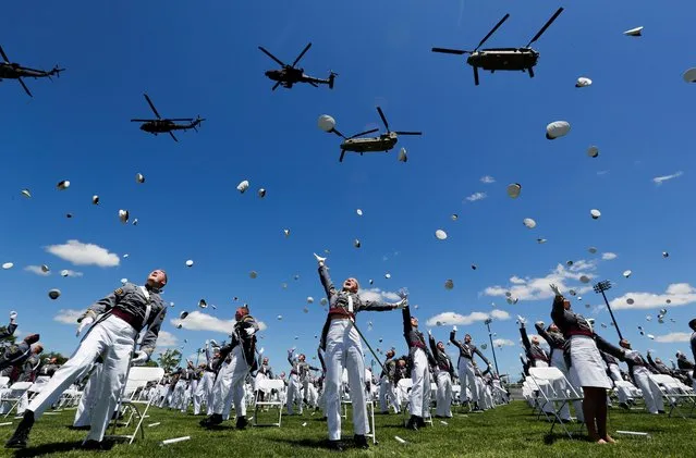 West Point graduating cadets throw their hats in the air in celebration as U.S. Army helicopters fly overhead at the culmination of their 2020 United States Military Academy Graduation Ceremony attended by U.S. President Donald Trump at West Point, New York, U.S., June 13, 2020. (Photo by Mike Segar/Reuters)