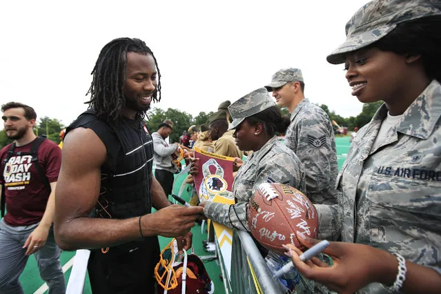 Redskins cornerback Josh Norman, left, signs autographs following the NFL football team's full practice session at the Redskins Park in Ashburn, Va., Wednesday, May 30, 2018. (Photo by Manuel Balce Ceneta/AP Photo)