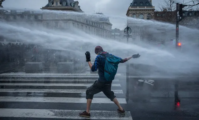 A truck-mounted water cannon sprays a protester during a demonstration against the Global Security Bill on January 30, 2021 at the Place de la République in Paris, France. France's lawmakers passed and adopted the bill known as article 24 of the “comprehensive security” law prohibiting the dissemination of images of the police, alarming journalists and activists saying civil liberties and press freedom could be compromised. Several MPs have criticised the bill's implications and President Macron has come under fire from national journalism unions and the UN for the law and police accountability. (Photo by Siegfried Modola/Getty Images)