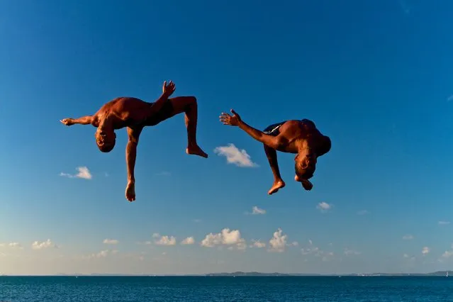 “Free!” Boys have fun jumping in the waters of the Bay of All Saints. Salvador, Bahia, Brazil. (Photo and caption by Marcio Pimenta/National Geographic Traveler Photo Contest)
