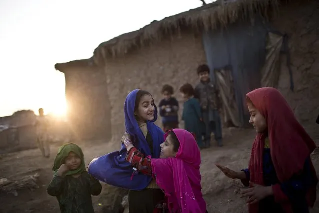 Afghan refugee girls play in a slum on the outskirts of Islamabad, Pakistan, Saturday, January 17, 2015. (Photo by Muhammed Muheisen/AP Photo)