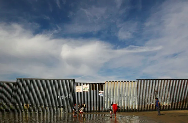 People are seen by a fence separating Mexico and the United States, in Tijuana, Mexico, November 12, 2016. (Photo by Jorge Duenes/Reuters)