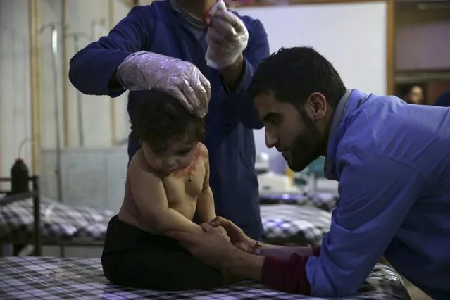 Medics treat an injured child inside a field hospital, after what activists said was shelling by forces loyal to Syria's President Bashar al-Assad, in the Douma neighborhood of Damascus, Syria November 29, 2015. (Photo by Bassam Khabieh/Reuters)