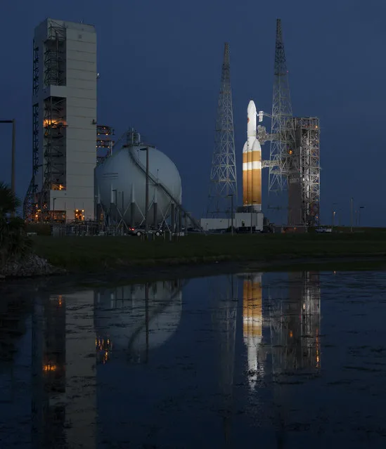 This photo provided by NASA shows the United Launch Alliance Delta IV Heavy rocket with the Parker Solar Probe onboard shortly after the Mobile Service Tower was rolled back, Friday, August 10, 2018, at Launch Complex 37 at Cape Canaveral Air Force Station in Fla. NASA is sending the spacecraft straight into the sun's glittering crown, an atmospheric region so hot and harsh any normal visitor would wither. Set to launch early Saturday, the Parker Solar Probe is as heat-resistant as a spacecraft gets, essential for exploring our star closer than ever before. (Photo by Bill Ingalls/NASA via AP Photo)