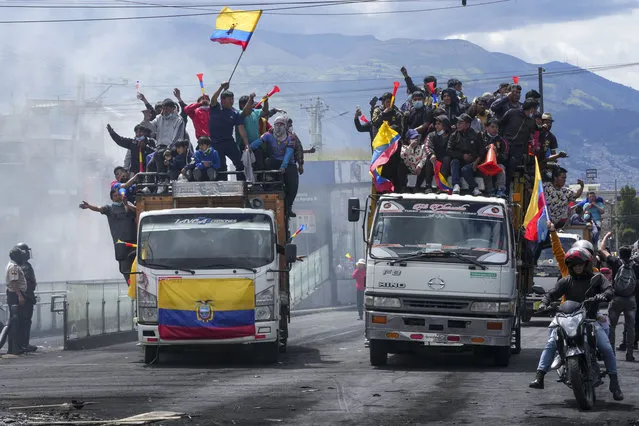 Anti-government protesters ride in trucks during demonstrations against the government of Guillermo Lasso called mainly by Indigenous organizations, in Quito, Ecuador, Thursday, June 16, 2022. (Photo by Dolores Ochoa/AP Photo)