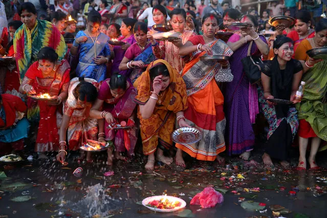 Hindu devotees release oil lamps to the Buriganga river as they observe Bipottarini Puja in Dhaka, Bangladesh, July 17, 2018. (Photo by Mohammad Ponir Hossain/Reuters)