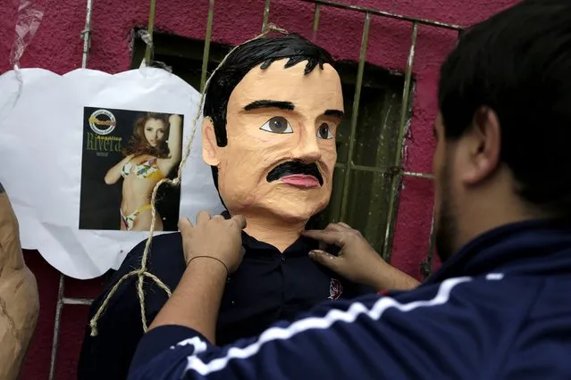 An artisan arranges a pinata depicting the drug lord Joaquin "El Chapo" Guzman outside his workshop in Reynosa, in Tamaulipas state, Mexico, January 13, 2016. (Photo by Daniel Becerril/Reuters)