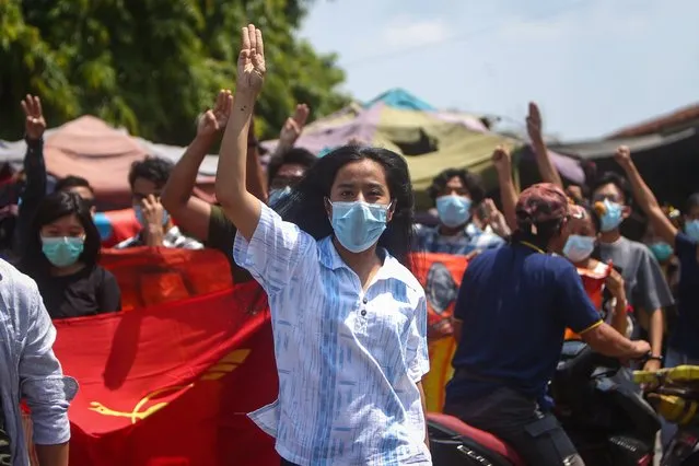Demonstrators flash the three-finger salute during an anti-military coup protest in Mandalay, Myanmar, 11 May 2021. 100 days have passed since the Myanmar military seized power on 01 February 2021, while more than 700 people were killed and thousands detained by Myanmar armed forces, according to the Assistance Association for Political Prisoners (AAPP). (Photo by EPA/EFE/Stringer)
