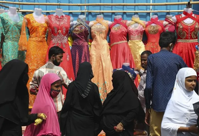In this May 13, 2021, file photo, Indian Muslims shop during a relaxation of lockdown to curb the spread of the coronavirus on the eve of Eid-al-Fitr in Hyderabad, India. (Photo by Mahesh Kumar A./AP Photo/File)