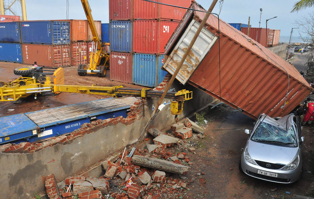 A shipping container lies in a street after falling from the walls around a harbour in Chennai on December 12, 2016. At least 10 people were killed when Cyclone Vardah slammed into the southern Indian tech hub of Chennai, bringing down houses and cutting off the electricity supply, authorities said December 13. Most were crushed by trees uprooted in winds of up to 140 kilometres (87 miles) per hour, which also cut power across large swathes of southern India on December 12. (Photo by AFP Photo/Stringer)