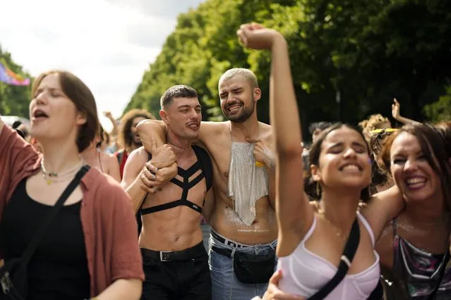 Revelers dance as they take part in the annual pride march in Berlin, Germany, Saturday, July 23, 2022. Draped in rainbow flags, around 150,000 people were marching for LGBTQ rights at Berlin's annual Christopher Street Day celebration. Berlin police gave the crowd estimate on Saturday afternoon but said the number could grow into the evening. (Photo by Markus Schreiber/AP Photo)