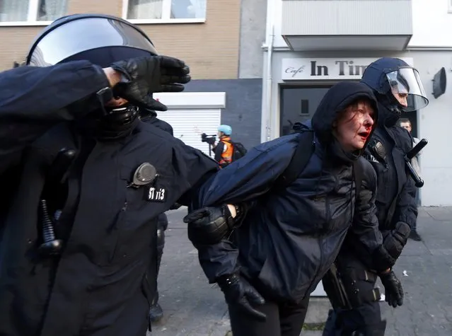 Policemen detain a wounded anti-capitalist “Blockupy” protester near the European Central Bank (ECB) building before the official opening of its new headquarters in Frankfurt March 18, 2015. (Photo by Michael Dalder/Reuters)