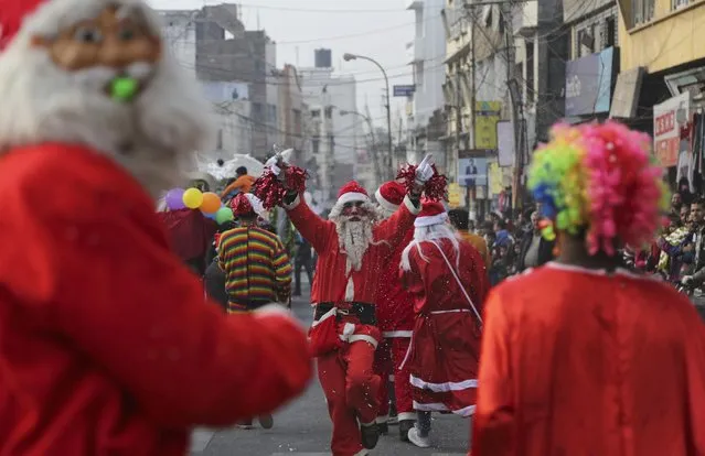 Indians dressed as Santa participate in a procession to celebrate Christmas in Jammu, India, Thursday, December 22, 2016. Christians make up about 2 percent of India's 1 billion-plus population. (Photo by Channi Anand/AP Photo)