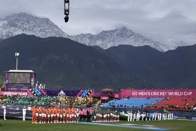 The Dhauladhar range of the Himalaya is seen covered with fresh snow as Netherlands and South Africa teams stand for their national anthems before the start of the delayed ICC Men's Cricket World Cup match between South Africa and Netherlands in Dharamshala, India, Tuesday, October 17, 2023. (Photo by Ashwini Bhatia/AP Photo)