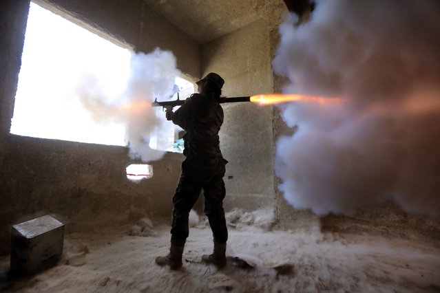 A female Syrian soldier from the Republican Guard commando battalion fires a rocket-propelled grenade (RPG) during clashes with rebels in the restive Jobar area, in eastern Damascus, on March 25, 2015. (Photo by Joseph Eid/AFP Photo)