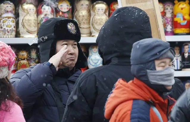 A Chinese tourist poses as he tries on a hat at a souvenir shop in Manezhnaya Square in central Moscow, Russia, February 5, 2016. (Photo by Sergei Karpukhin/Reuters)