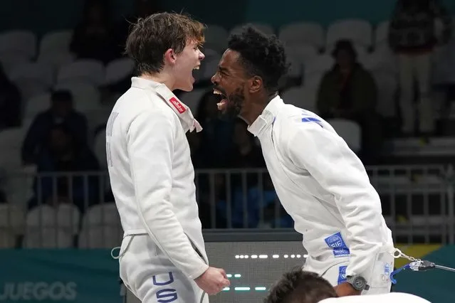 Samuel Imrek, left, and teammate Curtis McDowald, of the United States, celebrate their gold medal victory over Canada at the end of the men's fencing epee teams final, at the Pan American Games in Santiago, Chile, Thursday, November 2, 2023. (Photo by Eduardo Verdugo/AP Photo)