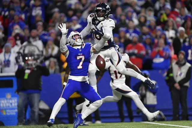 Buffalo Bills' Taron Johnson (7), left, breaks up a pass intended for Denver Broncos' Jerry Jeudy, top, during the second half of an NFL football game, Monday, November 13, 2023, in Orchard Park, N.Y. Johnson was called for pass interference on the play, allowing the Broncos to move into field goal range and win the game. (Photo by Adrian Kraus/AP Photo)
