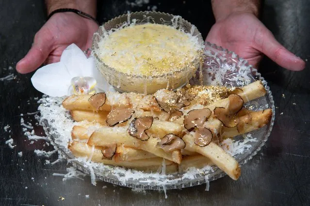 Chef Frederick Schoen-Kiewert serves The Creme de la Creme Pommes Frites, the world's most expensive french fries, according to the Guinness Book of World Records, at Serendipity 3 restaurant New York City, New York, U.S., July 23, 2021. (Photo by Eduardo Munoz/Reuters)