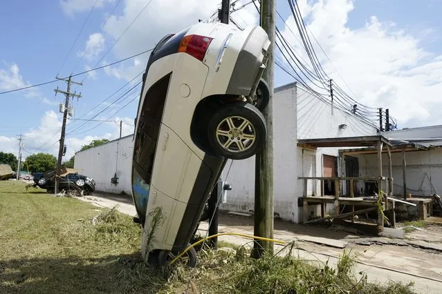 A car leans against a utility pole Sunday, August 22, 2021, in Waverly, Tenn. (Photo by Mark Humphrey/AP Photo)